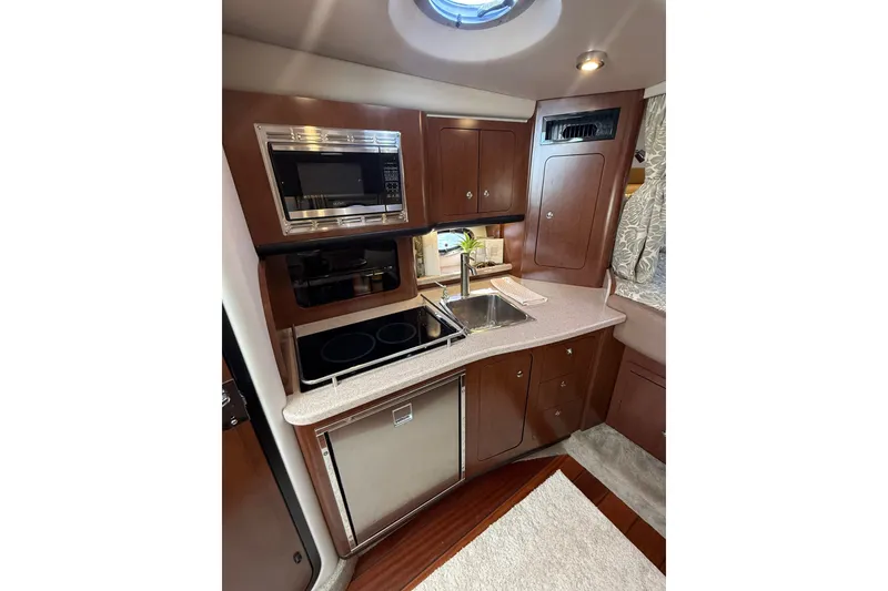 Slide: The Image of 2019 Crownline 350 SY yacht kitchen with modern appliances and sleek cabinetry. - 18