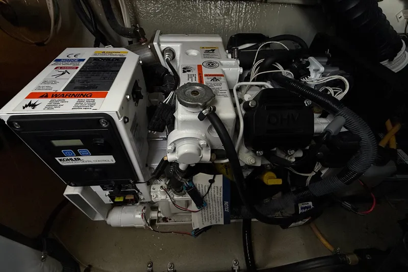 Slide: The Image of Engine compartment of a 2019 Crownline 350 SY boat featuring a Kohler generator. - 31