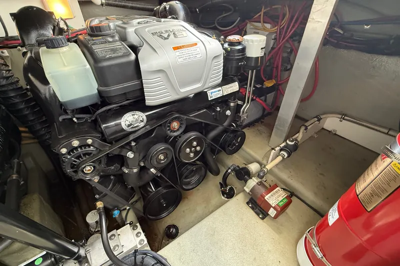 Slide: The Image of Engine compartment of a 2019 Crownline 350 SY boat with visible components and fire extinguisher. - 29