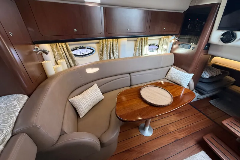 Slide: The Image of Luxurious interior of 2019 Crownline 350 SY yacht with elegant seating and wooden table. - 21