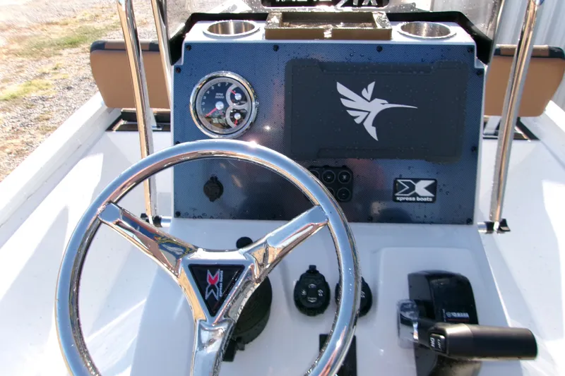 Slide: The Image of Steering console of 2026 Xpress XR21 Bay boat with modern controls and gauges. - 3
