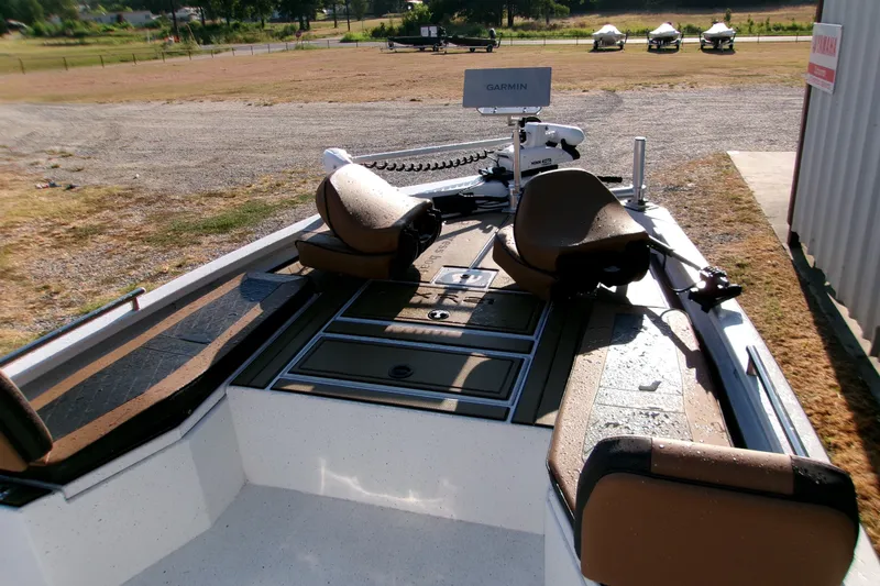 Slide: The Image of 2026 Xpress XR21 Bay boat with Garmin equipment, parked on a grassy area. - 17