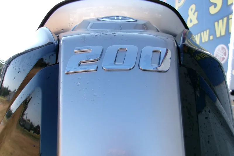 Slide: The Image of Close-up of 2026 Xpress XR21 Bay boat engine with "200" emblem. - 2