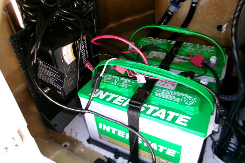 Slide: The Image of Battery compartment of 2026 Xpress XR21 Bay boat with Interstate batteries and charger. - 19