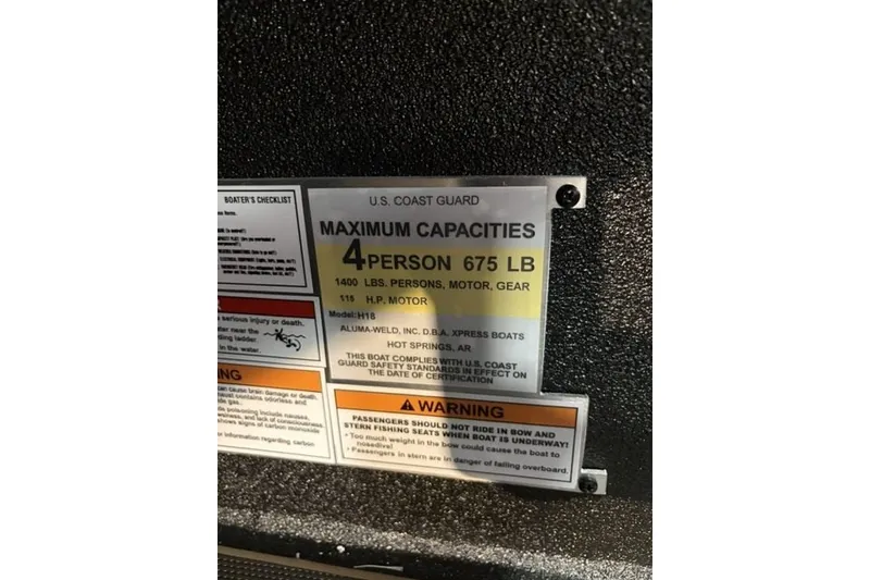Slide: The Image of 2027 Xpress H18 Bass boat capacity label, 4 persons, 675 lbs, 115 HP motor. - 18