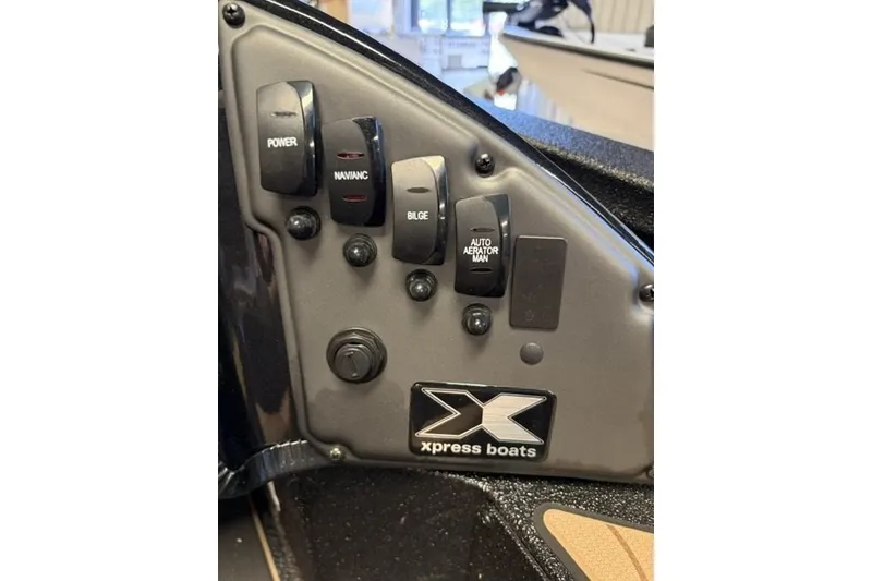 Slide: The Image of Control panel of 2027 Xpress H18 Bass boat with labeled switches. - 16