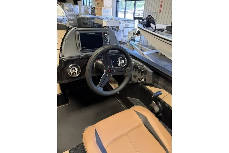 Slide: The Image of 2027 Xpress H18 Bass boat interior with steering wheel and control panel. - 15