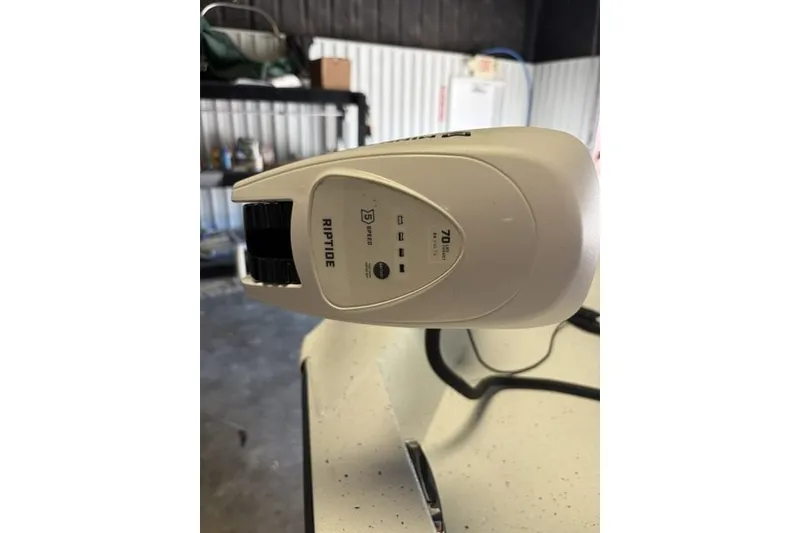Slide: The Image of Riptide motor on 2027 Xpress H20 Bay boat in a garage setting. - 8