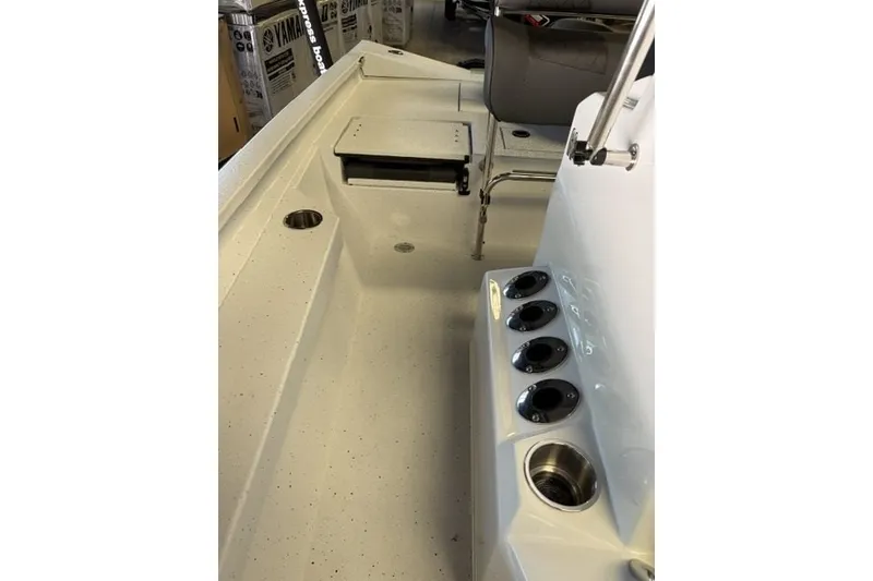 Slide: The Image of 2027 Xpress H20 Bay boat interior with rod holders and seating area. - 14