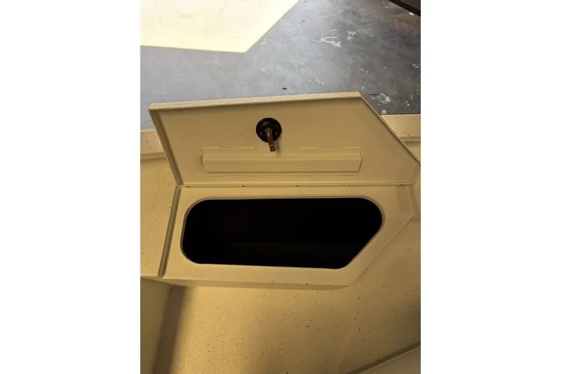 Slide: The Image of Open storage compartment on 2027 Xpress H20 Bay boat. - 11