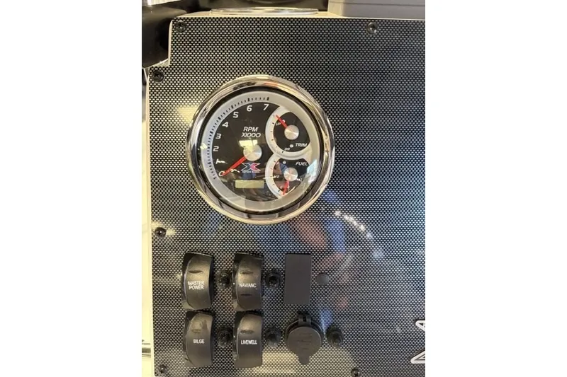 Slide: The Image of Dashboard of 2027 Xpress H20 Bay boat with RPM gauge and control switches. - 16