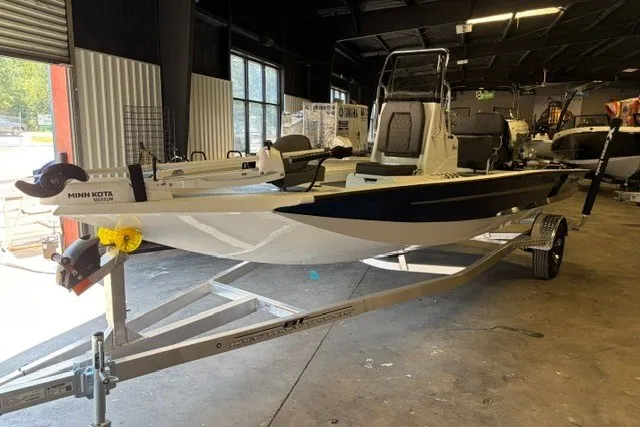 The Image of 2027 Xpress H20 Bay boat on trailer in a warehouse setting. - 1