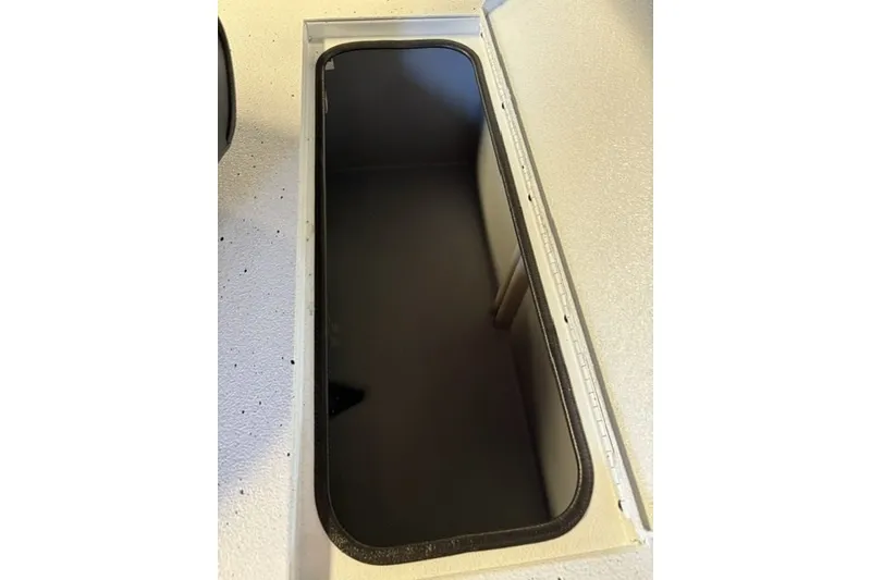 Slide: The Image of Open storage compartment on 2027 Xpress H20 Bay boat. - 21