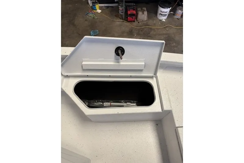 Slide: The Image of Open storage compartment on 2027 Xpress H20 Bay boat deck. - 10