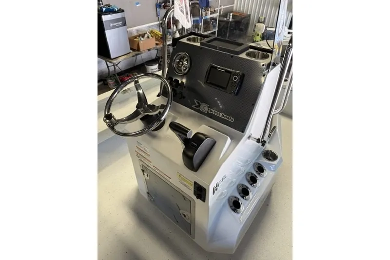 Slide: The Image of 2027 Xpress H20 Bay boat console with steering wheel and controls. - 15