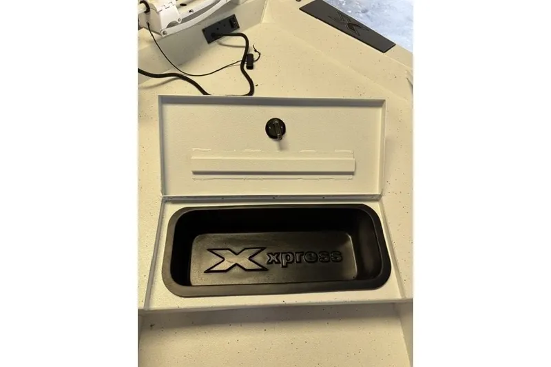 Slide: The Image of 2027 Xpress H20 Bay boat compartment with logo, featuring a secure latch. - 9