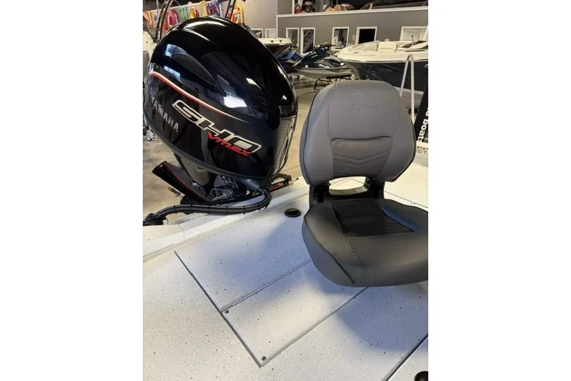 Slide: The Image of 2027 Xpress H20 Bay boat with Yamaha engine and gray seat in showroom. - 20