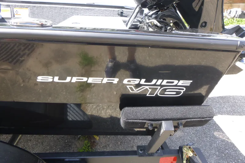 Slide: The Image of 2027 Tracker Super Guide V-16 SC boat, black exterior with model name displayed. - 14