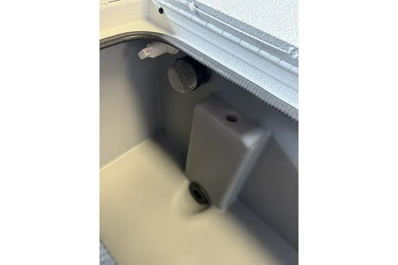 Slide: The Image of Interior compartment of 2027 Xpress H18 Bass boat, featuring drainage and ventilation components. - 16