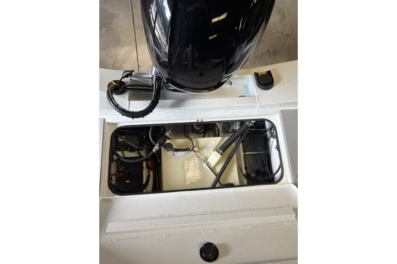 Slide: The Image of 2027 Xpress H18 Bass boat engine compartment with visible wiring and components. - 17