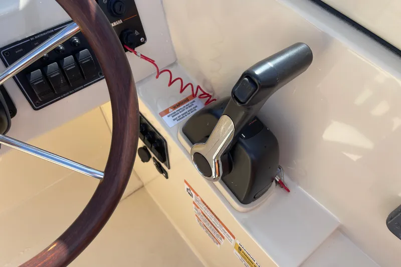 Slide: The Image of Steering wheel and throttle controls of 2022 Rossiter 20 boat cockpit. - 46
