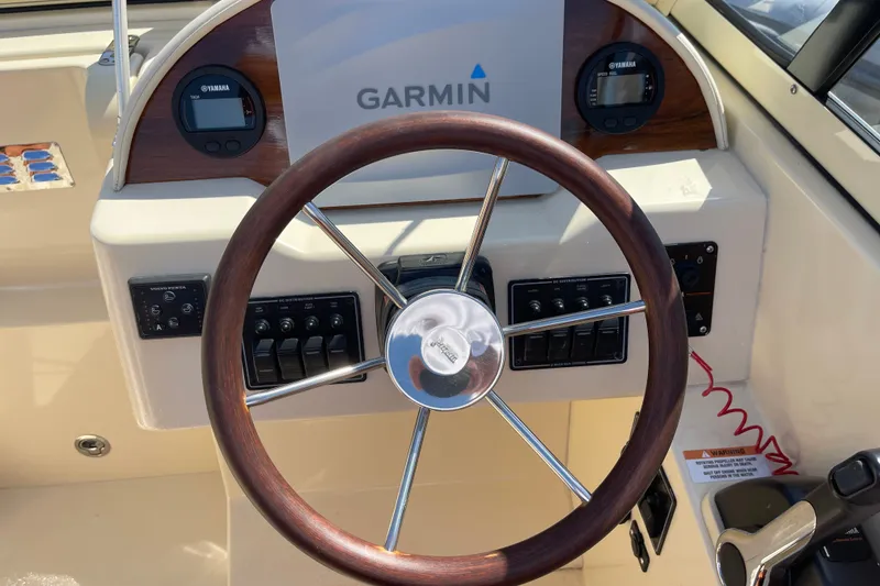 Slide: The Image of Steering wheel and dashboard of 2022 Rossiter 20 boat with Garmin display. - 45
