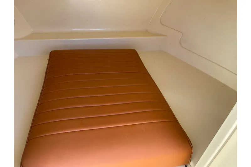 Slide: The Image of 2022 Rossiter 20 boat interior with brown cushioned seating. - 52