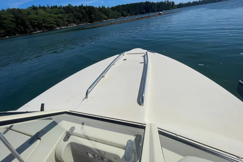 Slide: The Image of Bow view of 2022 Rossiter 20 boat on calm water near forested shoreline. - 53