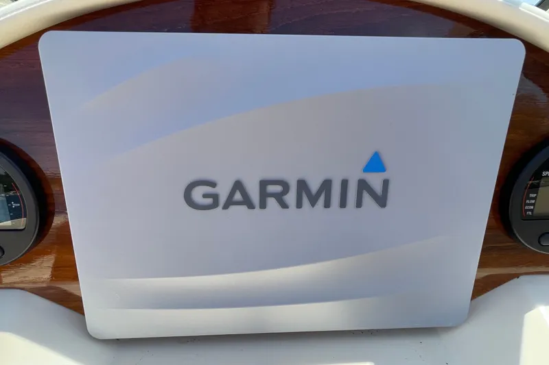 Slide: The Image of Garmin display on 2022 Rossiter 20 boat dashboard, featuring wooden paneling. - 43