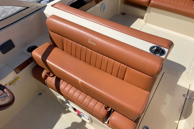 Slide: The Image of Luxurious brown leather seating on 2022 Rossiter 20 boat, featuring cup holders and elegant design. - 34