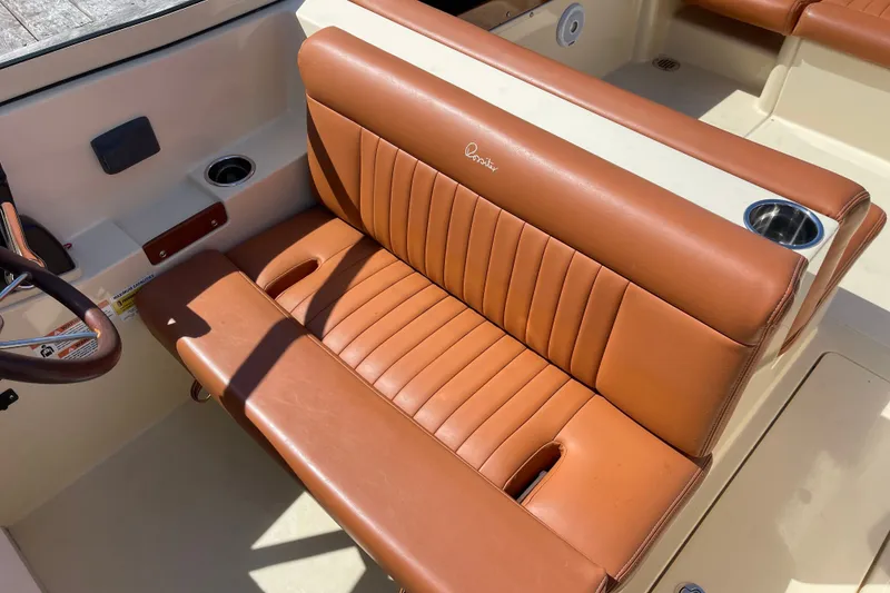 Slide: The Image of 2022 Rossiter 20 boat interior with brown leather seating and cup holders. - 35