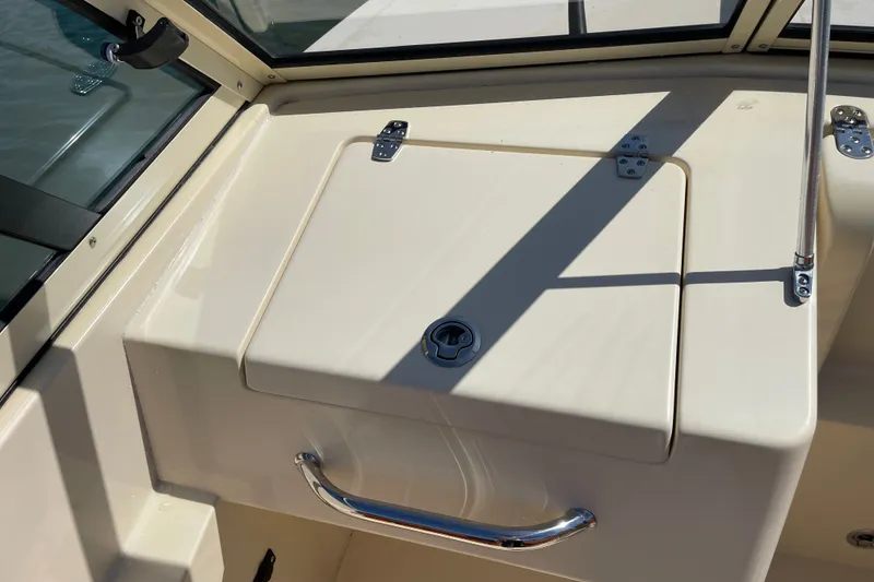 Slide: The Image of 2022 Rossiter 20 boat interior with storage compartment and chrome handle. - 40