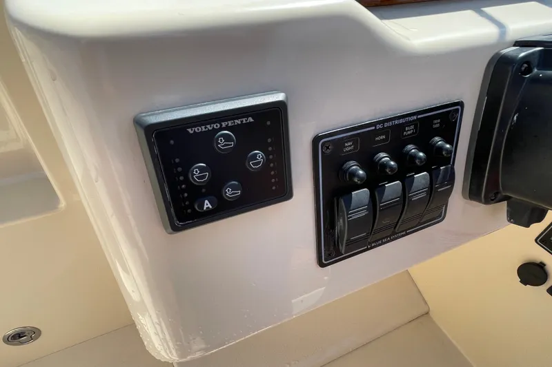 Slide: The Image of Control panel of a 2022 Rossiter 20 boat featuring Volvo Penta and Blue Sea Systems. - 44
