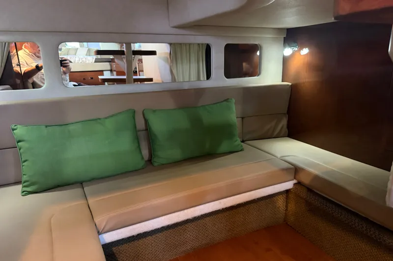 Slide: The Image of Interior of 2012 Sea Ray Sundancer 330 with beige seating and green cushions. - 23