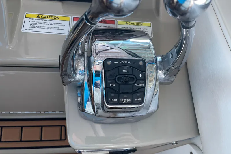 Slide: The Image of Throttle controls on a 2012 Sea Ray 330 Sundancer boat dashboard. - 13