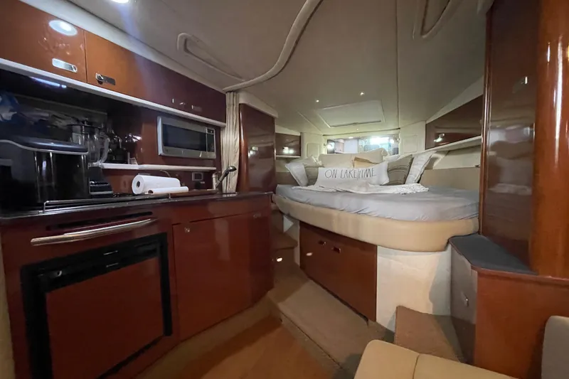 Slide: The Image of Luxurious interior of 2012 Sea Ray 330 Sundancer yacht with cozy bed and kitchenette. - 22