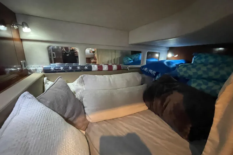 Slide: The Image of Cozy interior cabin of 2012 Sea Ray 330 Sundancer with plush pillows and ambient lighting. - 21