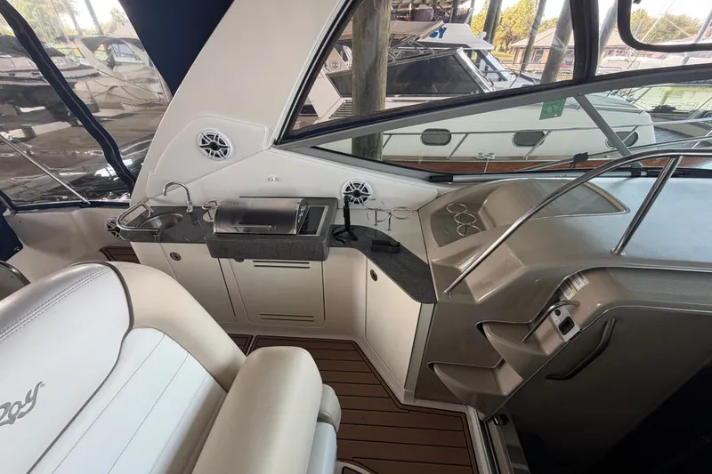 Slide: The Image of 2012 Sea Ray Sundancer 330 interior with kitchenette and seating area. - 31