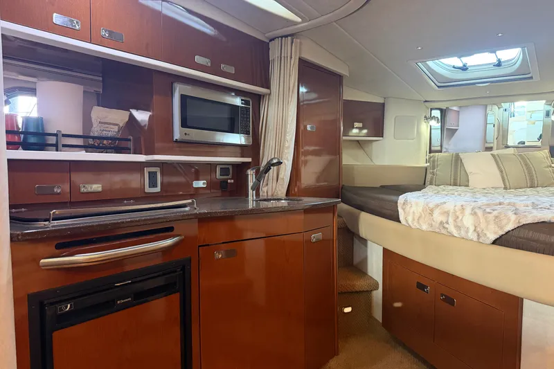 Slide: The Image of Luxurious interior of 2012 Sea Ray Sundancer 330 yacht with kitchenette and cozy sleeping area. - 24