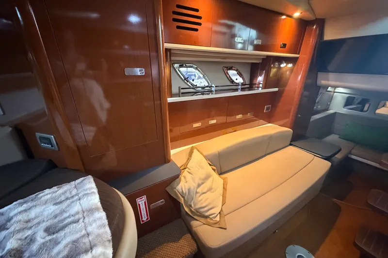 Slide: The Image of Luxurious interior of 2012 Sea Ray Sundancer 330 yacht with plush seating and elegant wood finishes. - 27