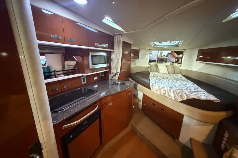 Slide: The Image of Luxurious interior of 2012 Sea Ray Sundancer 330 yacht with kitchenette and cozy sleeping area. - 25