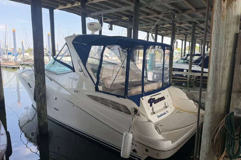 The Image of 2012 Sea Ray Sundancer 330 docked in marina, covered with blue canopy. - 0