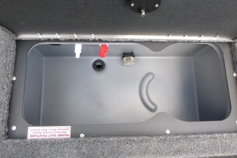 Slide: The Image of 2027 Tracker Targa V-19 Combo boat storage compartment with pump-out feature and carpeted interior. - 15