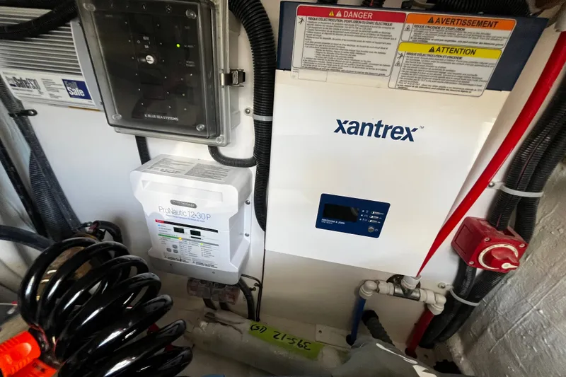 Slide: The Image of Electrical system components in a 2024 Tartan 395, featuring Xantrex and ProNautic devices. - 15
