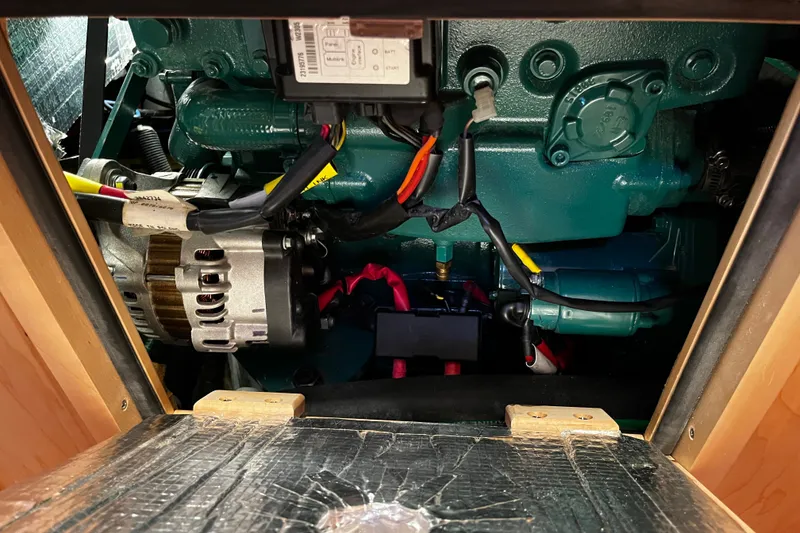 Slide: The Image of Engine compartment of a 2024 Tartan 395 sailboat, showcasing mechanical components and wiring. - 24