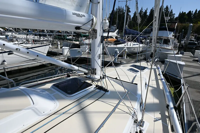 Slide: The Image of 2024 Tartan 395 sailboat docked at marina, showcasing deck and rigging details. - 26