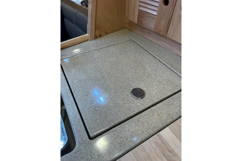 Slide: The Image of 2024 Tartan 395 yacht interior with sleek countertop and wooden cabinetry. - 17