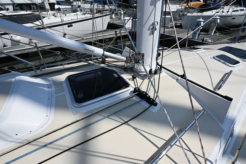 Slide: The Image of 2024 Tartan 395 sailboat deck with rigging and hatches at a marina. - 28