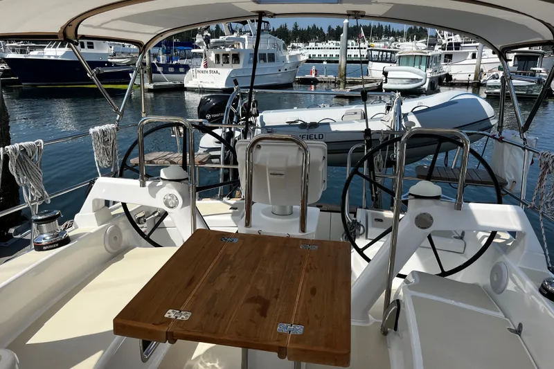 Slide: The Image of Cockpit view of 2024 Tartan 395 yacht docked at marina with boats in background. - 56