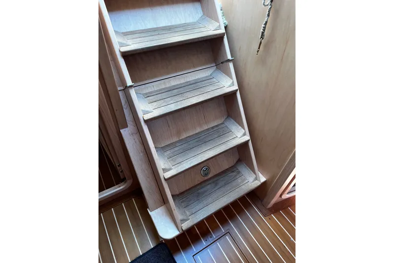 Slide: The Image of Wooden interior stairs on a 2024 Tartan 395 yacht. - 19